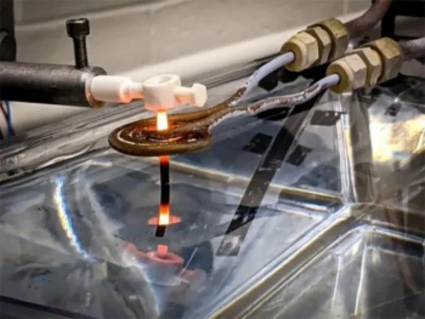 A thin 3D printed superalloy rod is pulled out of the water bath A thin 3D printed superalloy rod is pulled out of the water bath